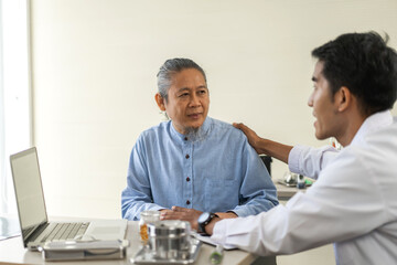 Obraz premium Asian man doctor wearing uniform with stethoscope help discussing and consulting talk to sick senior patient checkup information, support, care, diseases, treatment in hospital.elderly healthcare