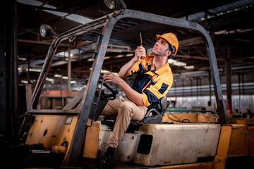 Fototapeta na wymiar Worker industry factory wear safety uniform factory drive forklift truck moving goods to industry production shelves in factory warehouse area is industry transportation business concept.