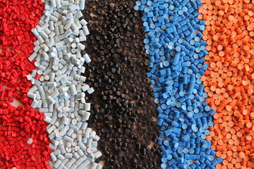 Multi colored heaps of molding compounds plastic pellets.