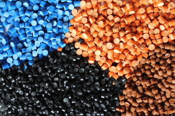 Multi colored heaps of molding compounds plastic pellets.