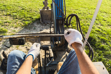 Man operating his old excavator during his work on a construction site