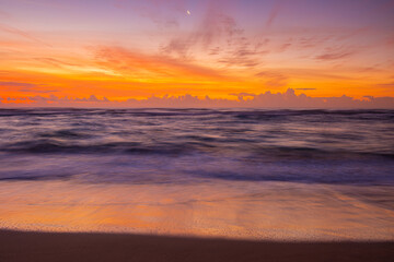 Fototapeta na wymiar Sunrise on The Waves and The Sandy Shore of Lydgate Beach, Lydgate Beach Park, Kauai, Hawaii, USA