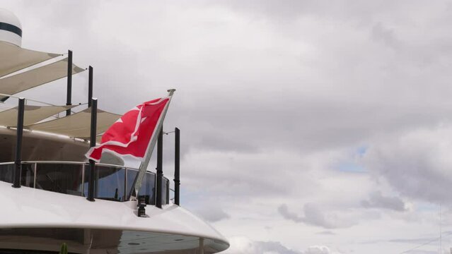 Flag with maltese cross waving on yacht