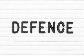 Black color letter in word defence on white felt board background