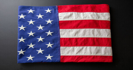 American flag folded on black abackground, US America National Holiday
