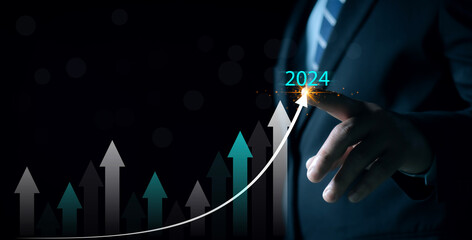New years 2024 start up investment new business and finance. Businessman hand pointing graph on...