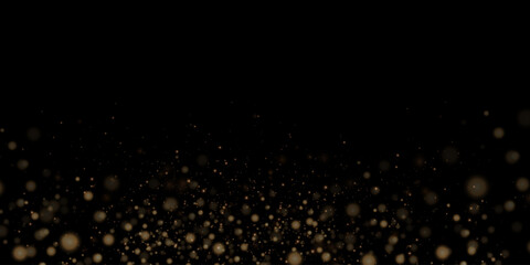 Glittering golden particles of fairy dust on a black background. Christmas sparkling light effect, sparks, glowing lights, sparks and dust and star shine with special light.