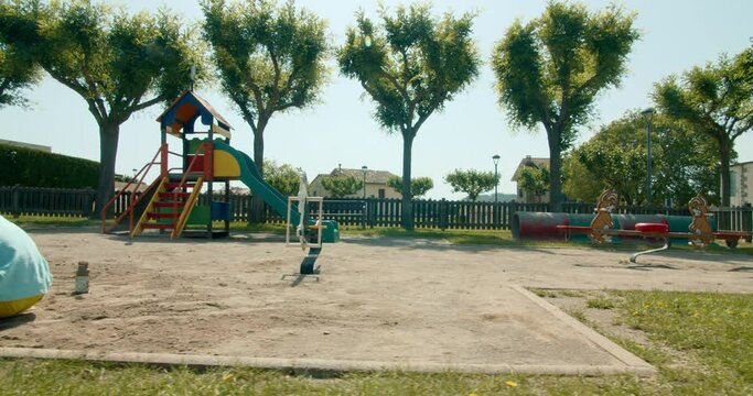 Two children playing with sand on playground at summertime