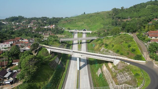 Aerial footage of the iconic Cisumdawu twin tunnel toll road in Sumedang district, West Java, Indonesia