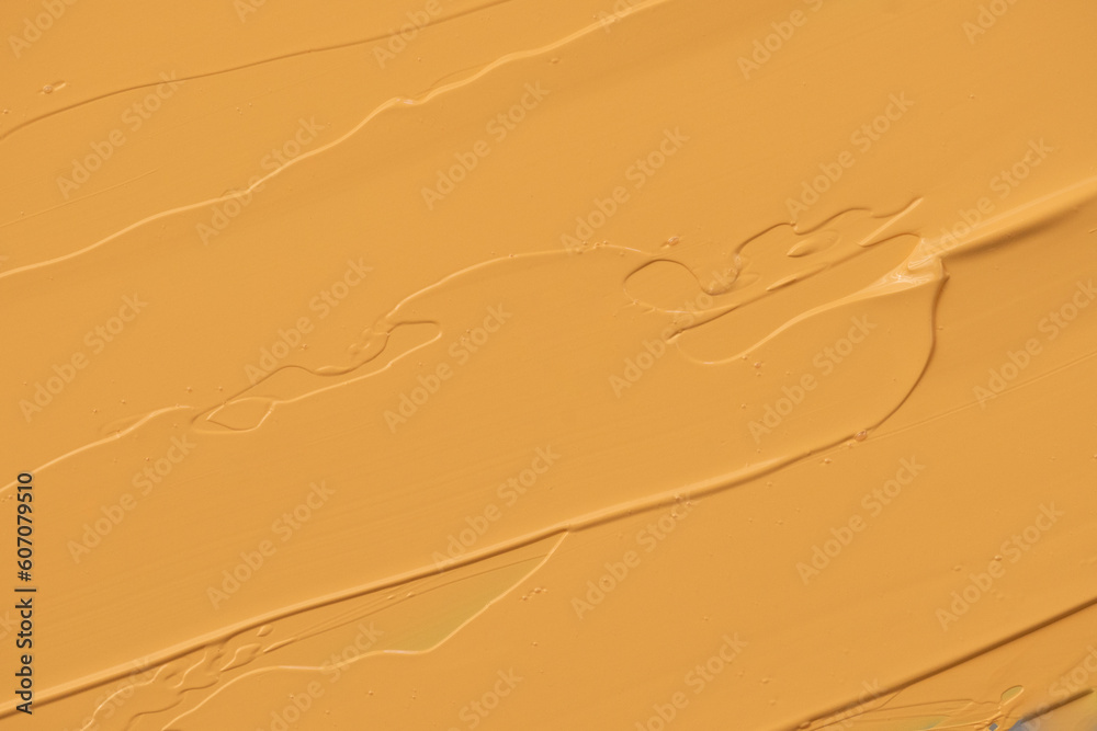 Aufkleber abstract yellow paint texture background. face cream smeared with a spatula