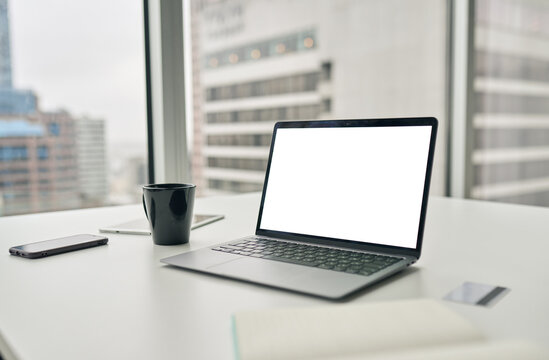 Laptop with white mock up empty blank screen on desk in office business background. Modern computer with mockup display template technology device on modern workspace table concept.