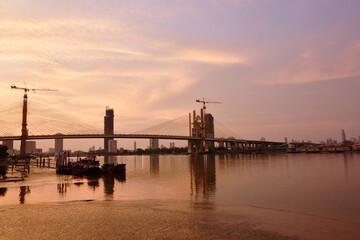 Fototapeta na wymiar new Rama nine suspension bridge under construction cross Chao Phraya river in Thailand on sunset