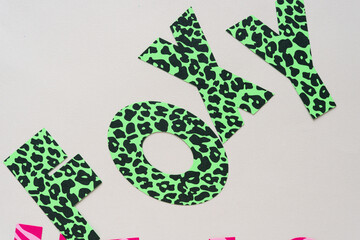 machine-cut paper letters forming the word: foxy