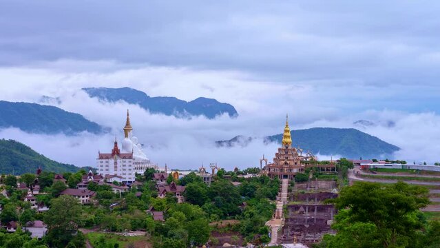 timelapse mist are moving around beautiful golden pavilion and the beautiful 5 statues buddha of Wat Phachonkeaw. .the famous landmark of Phetchabun province Thailand. mist in the valley background