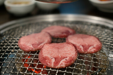 Korean Style Barbecue Grill BBQ rare beef tongue meat with soft focus