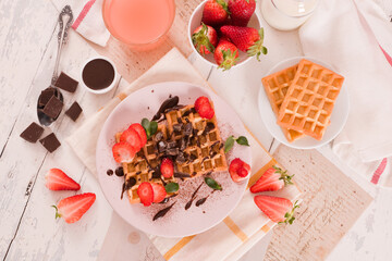 Waffles with strawberries and chocolate cream. - 607098574