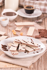 Neapolitan wafers filling with hazelnut-chocolate cream. - 607098729