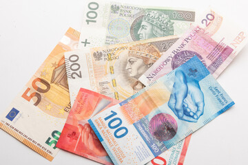 Obraz premium polish zloty, swiss francs and euro currency coins and banknotes