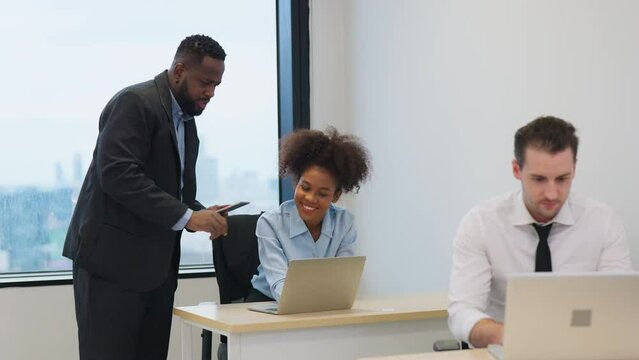 Diverse employees gathered in the office brainstorming and share idea for new project with laptop. Presents e-Commerce Statistics to a Group of Investors with big data support. Business and finance co