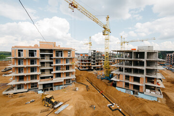 Modern townhouses in a residential area with multiple new apartments buildings surrounded by green outdoor facilities in central calm neighborhood