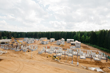 photo of a large construction site of private modern cottages in a trendy premium residential area with an individual design