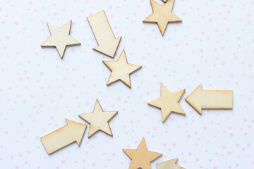 stars and arrows wooden embellishments arranged on scrapbook paper