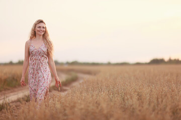 Fototapeta na wymiar girl walks along an agricultural field road