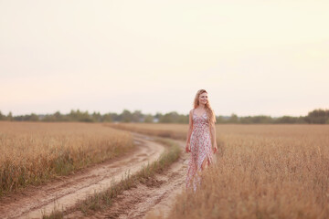 girl walks along an agricultural field road