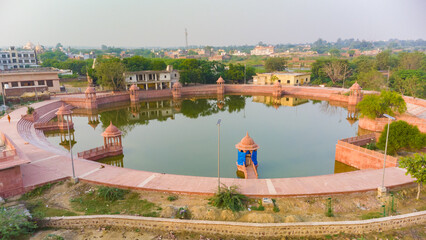 photo taken from a drone, sacred place uddhava kunda on govardhan hill in india, girl in prayer,...