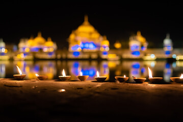 fire lamps on the background of the shrine, night view, sacred place kusum sarovar on govardhan...