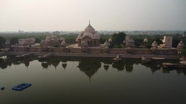 drone filming at sunset, sacred place kusum sarovar on govardhan hill, temple in india, place of pilgrimage