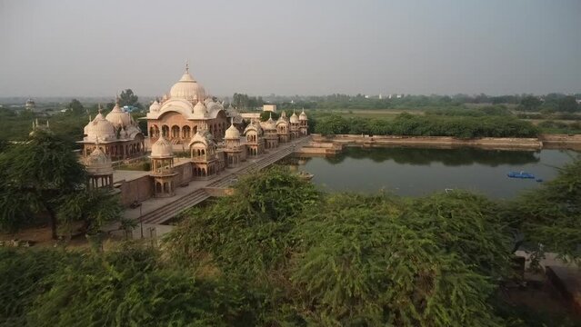 drone filming at sunset, sacred place kusum sarovar on govardhan hill, temple in india, place of pilgrimage