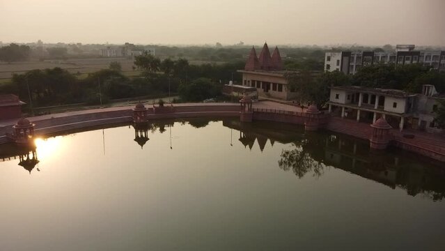 drone filming at sunset, narada kunda lake, sacred place on govardhan hill in india, place of pilgrimage, shrine of believers