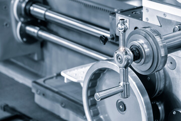 Lathe control knobs close up blue tone. Metal machine tools industry. The metalworking process by turning machine. industry metal processing concept background