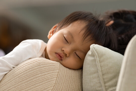 Close up Happy asian baby lying sleeps on bed sweet dream calm comfort and safety. Sleeping baby napping relax at warmth place deep sleep and fresh breathing. Newborn Baby Sleep concept. Zoom out shot