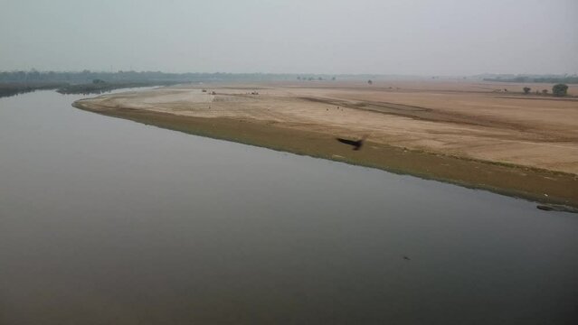 drone filming at sunset, farmers field on the bank of sacred river yamuna in vrindavan in india