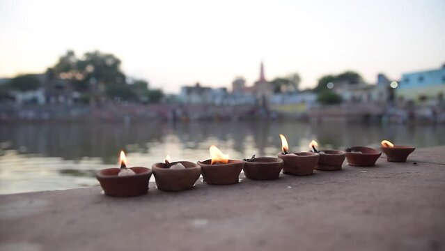 fire lamps on the background of the shrine, night view, sacred place radha kunda on govardhan hill, temple in india, place of pilgrimage