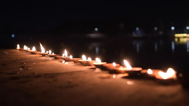 fire lamps on the background of the shrine, night view, sacred place kusum sarovar on govardhan hill, temple in india, place of pilgrimage