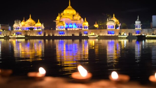 fire lamps on the background of the shrine, night view, sacred place kusum sarovar on govardhan hill, temple in india, place of pilgrimage