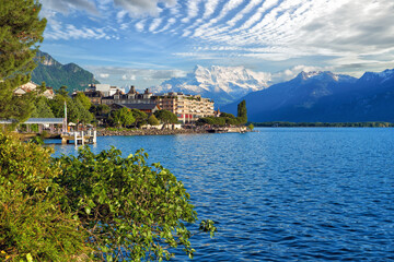 Evening view of Lake Geneva with picturesque shores against Alpine mountains in the rays of the setting sun in Montreux, Switzerland
