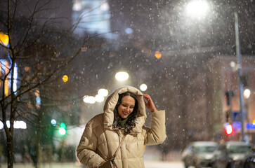 Woman walking in the city at night