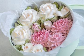 Zephyr bouquet of flowers in a gift box on a light background