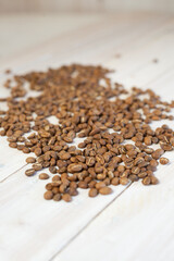 roasted coffee beans on white wooden table. timber background, top view, copy space