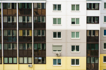 Modern residential multi-storey building. Windows and balconies on a new residential building close-up. Buying and selling apartments, rental housing, happy family life in a comfortable apartment.