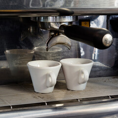 Cups in a coffee machine.