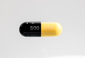 medicine capsule black and yellow  on white background
