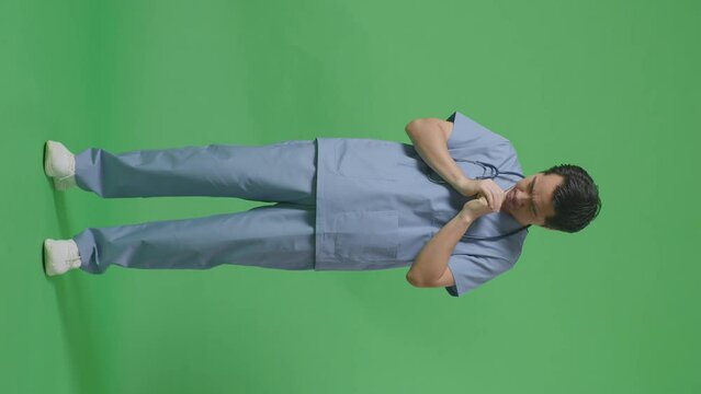 Full Body Of Asian Male Doctor With Stethoscope Pray For Something On Green Screen Background In The Hospital
