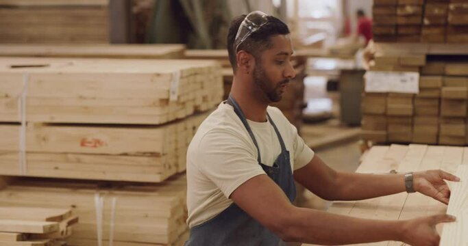 Warehouse, man and tired storage worker with wood, product or lumber, working and carpenter with burnout. Indian employee, factory and exhausted headache and apron, plank and building material