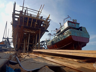 The process of making wooden fishing boats on the wharf. Docking shipyard
