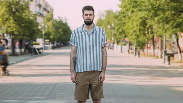 Zoom-out Time Lapse Portrait Of Handsome Young Man Standing In Metropolis On Summer Day. Crowds Of People Rushing Around In Busy Street.